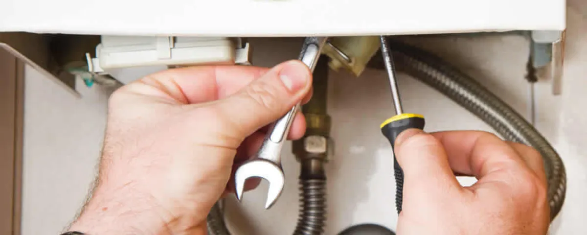 Boiler repair technician tightening pipe fittings and connections in Clearwater, FL