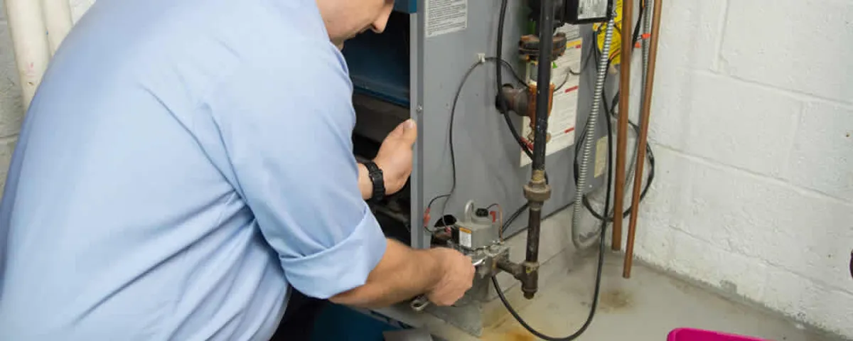 Furnace repair technician inspecting and servicing a home heating system in Clearwater, FL