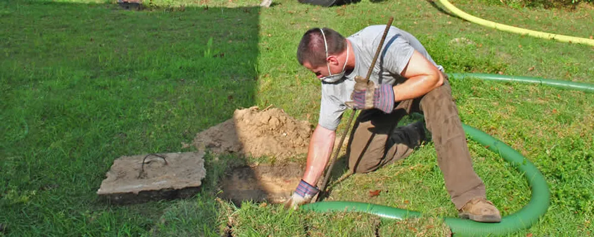 Septic pumping technician servicing a residential septic tank in Clearwater, FL