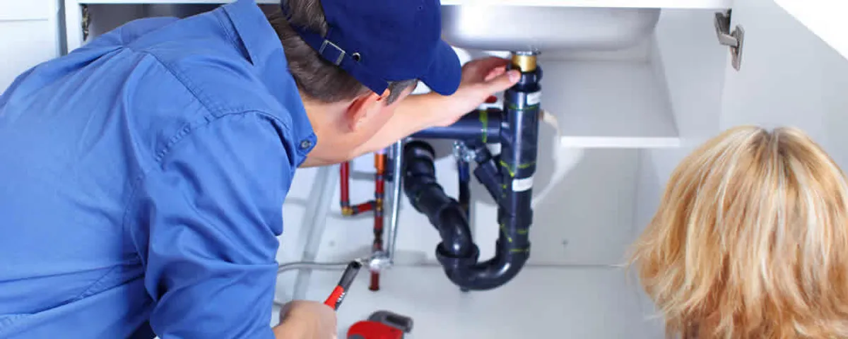 Plumber repairing under-sink drain pipes and fittings in Clearwater, FL